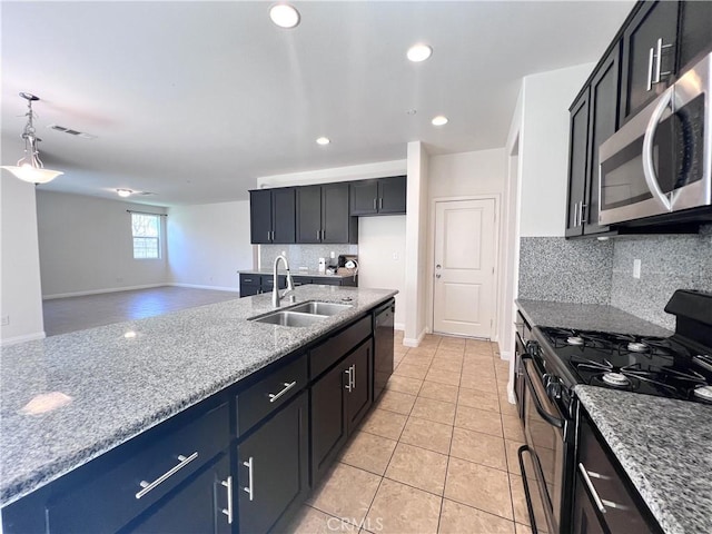 2866 S Via Belamaria, Ontario, CA 91762 - kitchen with a sink, backsplash, appliances with stainless steel finishes, light stone countertops, and visible vents