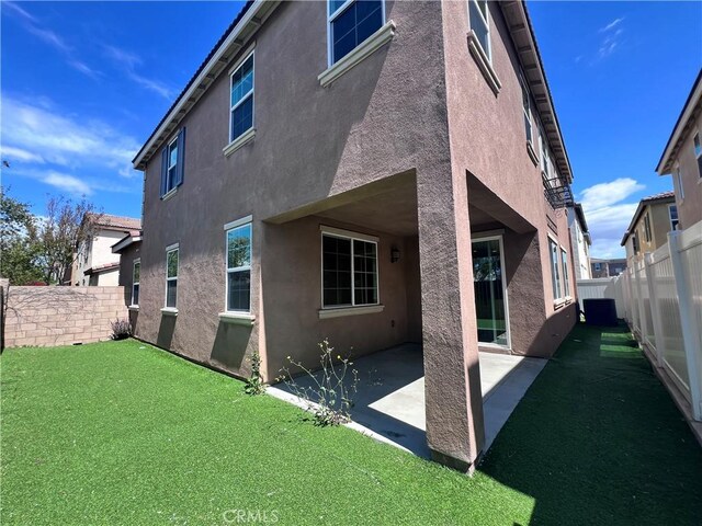 2866 S Via Belamaria, Ontario, CA 91762 - rear view of house with a patio area, a fenced backyard, and stucco siding