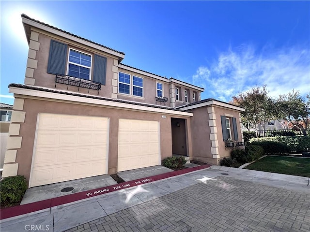 2866 S Via Belamaria, Ontario, CA 91762 - view of front facade with an attached garage, a tile roof, decorative driveway, and stucco siding