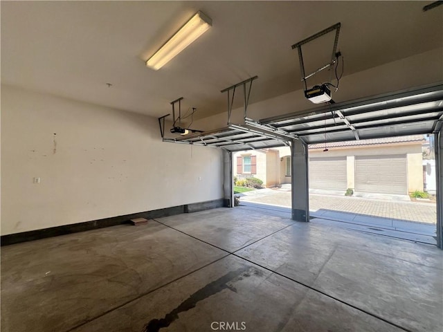 2866 S Via Belamaria, Ontario, CA 91762 - garage with baseboards and a garage door opener