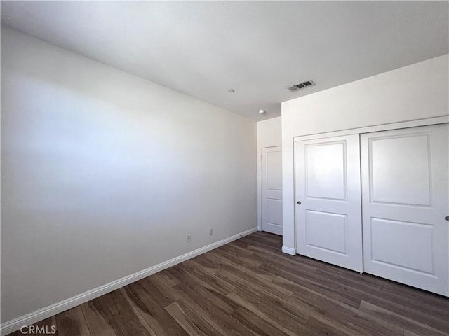 2866 S Via Belamaria, Ontario, CA 91762 - unfurnished bedroom featuring baseboards, visible vents, dark wood-type flooring, and a closet
