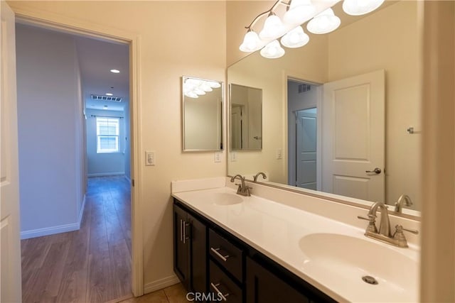 2866 S Via Belamaria, Ontario, CA 91762 - bathroom with baseboards, visible vents, a sink, and double vanity