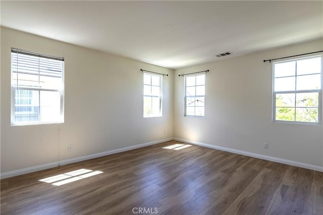 2866 S Via Belamaria, Ontario, CA 91762 - spare room featuring baseboards, wood finished floors, and visible vents