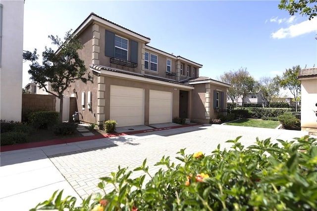 2866 S Via Belamaria, Ontario, CA 91762 - view of front of property with stucco siding, a tile roof, fence, and a garage