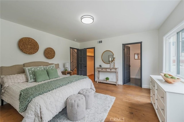 24422 Los Codona Ave, Torrance, CA 90505 - bedroom with light wood-style floors, a spacious closet, and baseboards