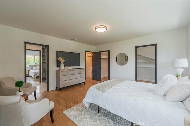 bedroom with wood finished floors and visible vents
