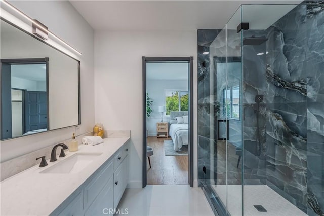 ensuite bathroom featuring a marble finish shower, vanity, and ensuite bath