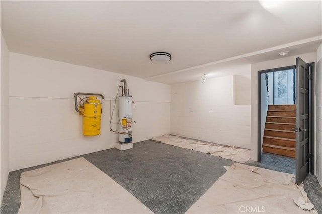 garage with concrete block wall and water heater
