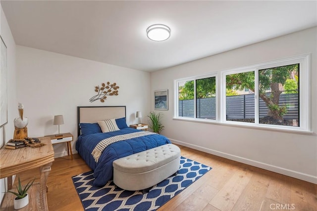 bedroom with baseboards and light wood-style floors