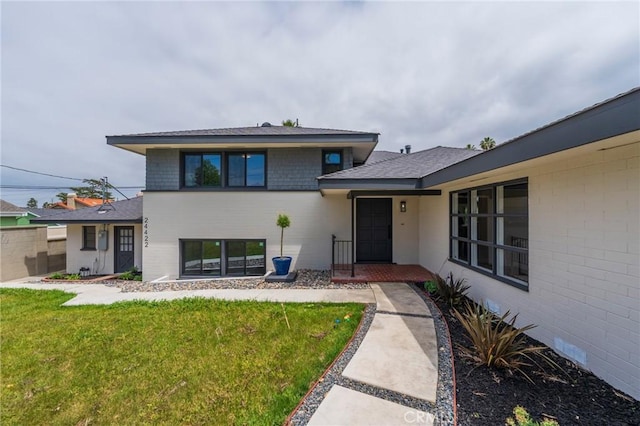 24422 Los Codona Ave, Torrance, CA 90505 - view of exterior entry with a lawn and a shingled roof