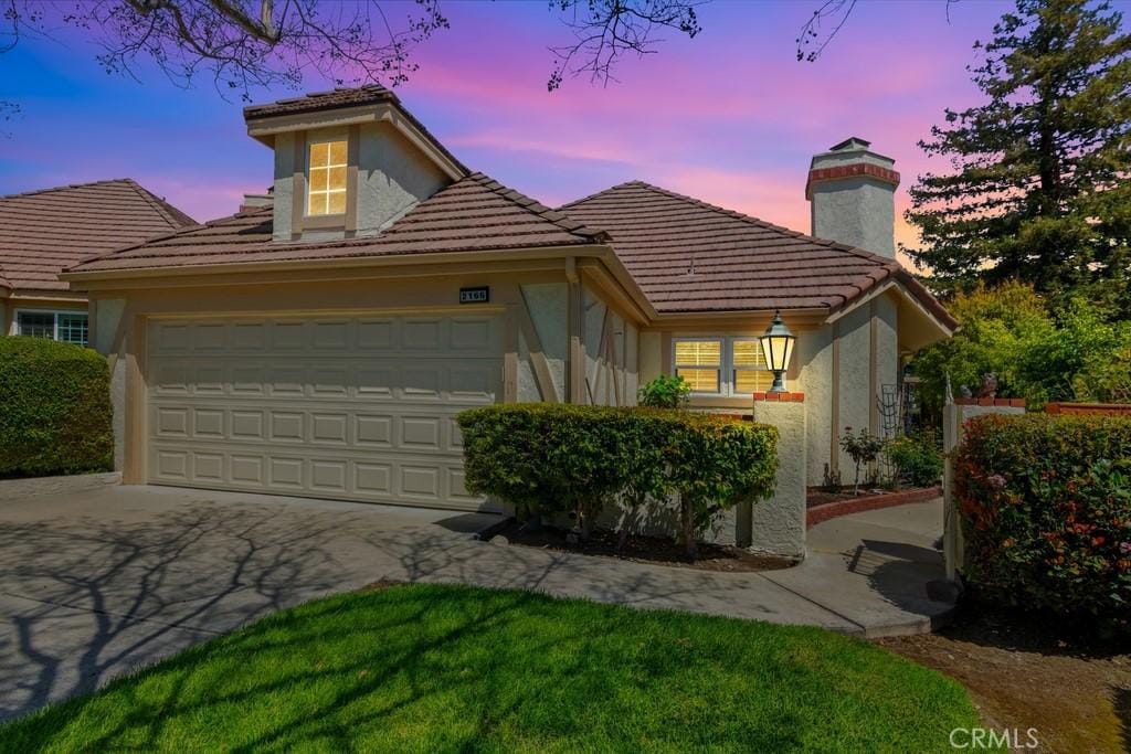 2166 Malati Cir, Upland, CA 91784 - view of front of home featuring a chimney, a garage, stucco siding, and a tile roof