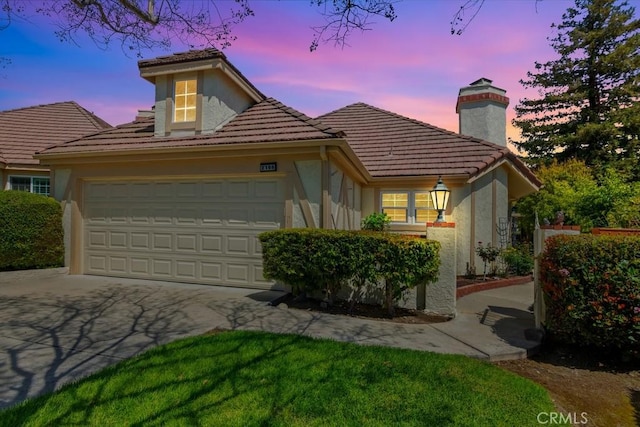 2166 Malati Cir, Upland, CA 91784 - view of front of home featuring a chimney, a garage, stucco siding, and a tile roof
