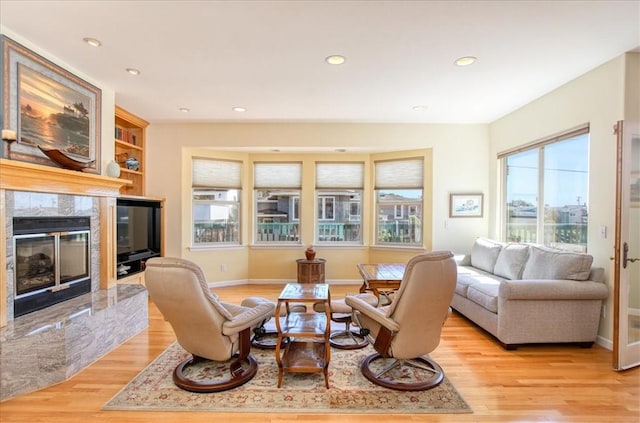 347 Ivar St, Cambria, CA 93428 - living room featuring baseboards, recessed lighting, a high end fireplace, and light wood-style floors