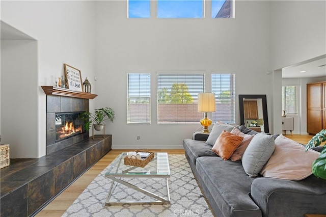 32177 Clear Springs Dr, Winchester, CA 92596 - living area with a towering ceiling, a tile fireplace, and light wood-type flooring