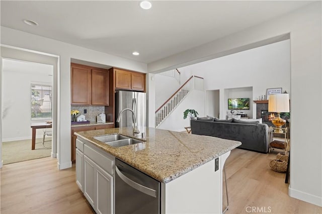 32177 Clear Springs Dr, Winchester, CA 92596 - kitchen featuring stainless steel appliances, light wood-style flooring, light stone countertops, decorative backsplash, and recessed lighting