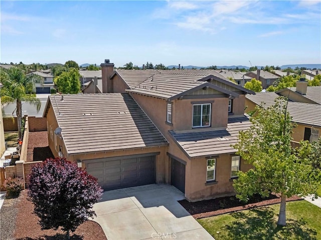 32177 Clear Springs Dr, Winchester, CA 92596 - view of front of house featuring stucco siding, driveway, a garage, and a residential view