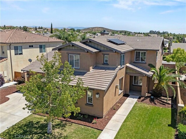 32177 Clear Springs Dr, Winchester, CA 92596 - view of front of house with stucco siding, roof mounted solar panels, a front lawn, and a tile roof