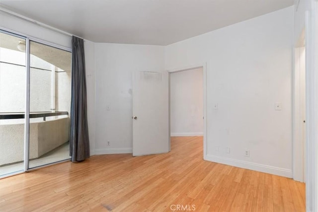 unfurnished bedroom featuring light wood-style floors and baseboards