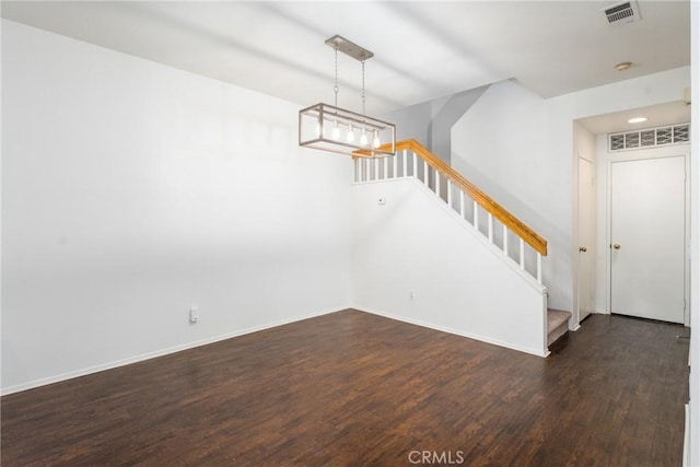 interior space with baseboards, visible vents, stairs, and dark wood-style flooring