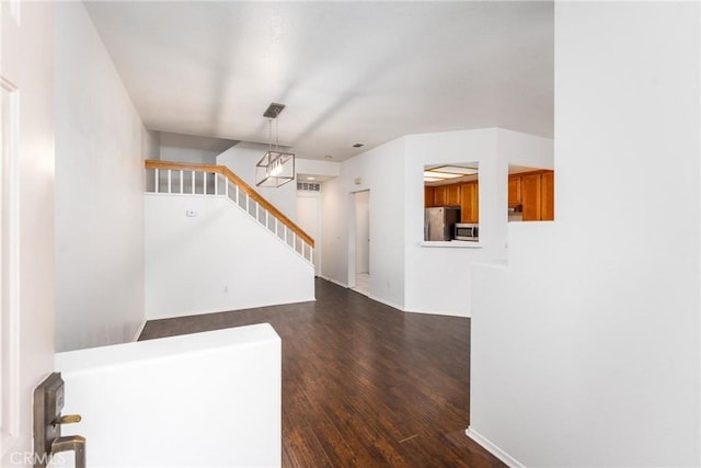 entrance foyer with stairway and dark wood-style flooring