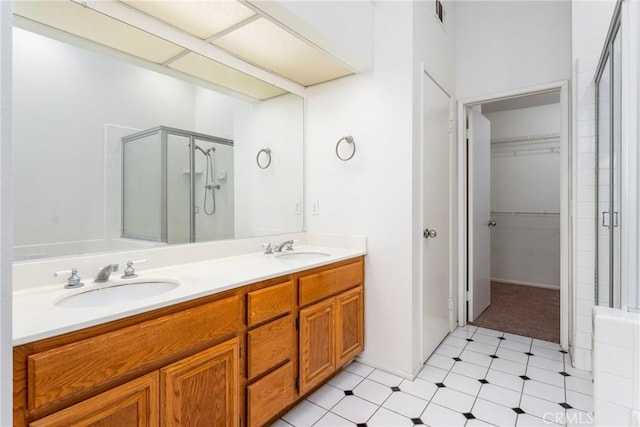 bathroom featuring visible vents, a shower stall, and a sink
