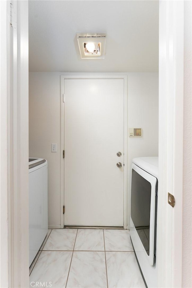 washroom featuring washer and clothes dryer and laundry area