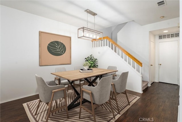 dining space with baseboards, visible vents, stairs, and dark wood-type flooring