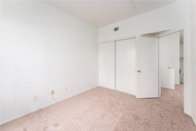 unfurnished bedroom with visible vents, baseboards, carpet flooring, and a closet