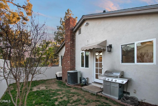 3447 Burritt Way, La Crescenta, CA 91214 - rear view of property featuring stucco siding, central AC, a fenced backyard, and a chimney
