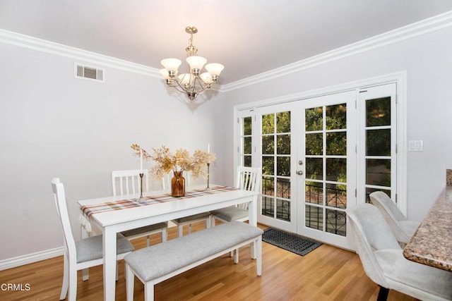 3447 Burritt Way, La Crescenta, CA 91214 - dining area featuring a chandelier, french doors, crown molding, wood finished floors, and baseboards