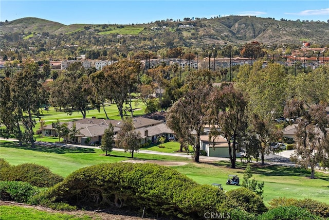 view of home's community with a lawn, a residential view, a mountain view, and view of golf course