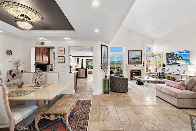 dining area featuring a lit fireplace, stone tile floors, visible vents, baseboards, and recessed lighting