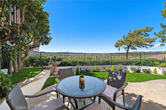 view of patio with outdoor dining area and a fenced backyard