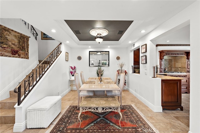 dining room with a tray ceiling, recessed lighting, baseboards, visible vents, and stairs