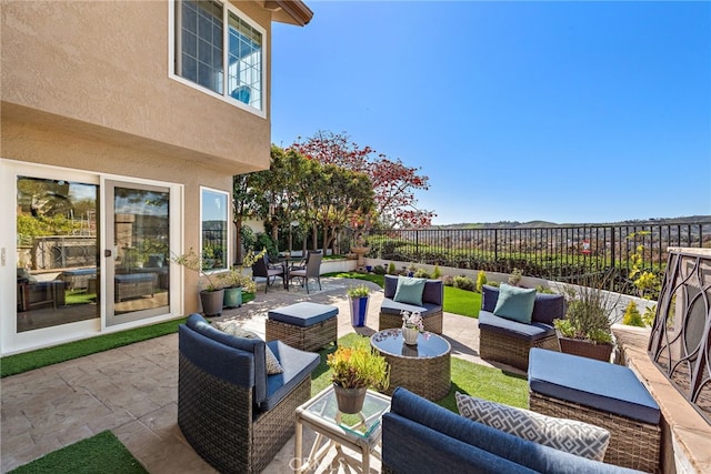 view of patio with an outdoor hangout area and fence
