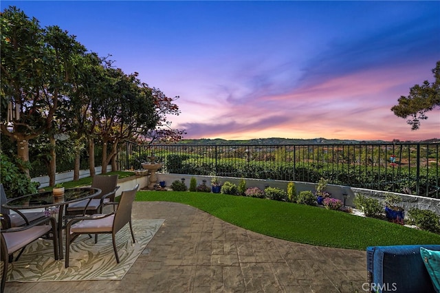 view of patio with outdoor dining space and a fenced backyard