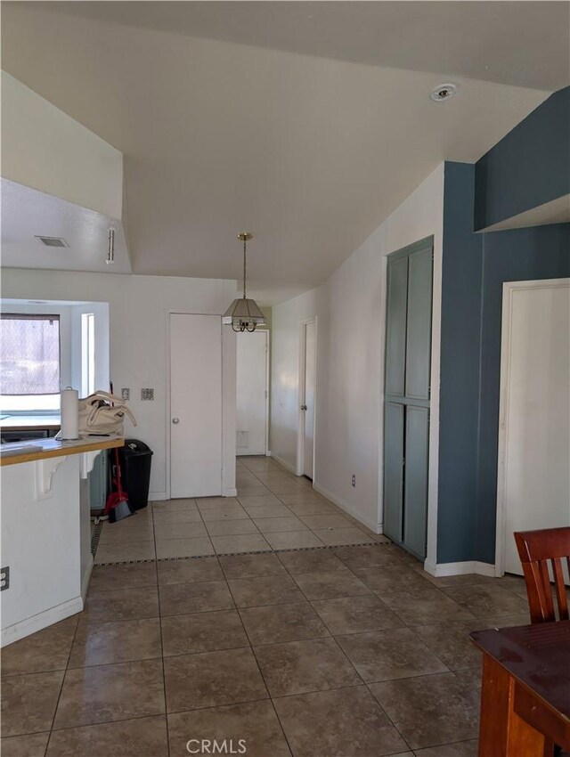 624 Kesha Ct, San Jacinto, CA 92583 - unfurnished dining area with vaulted ceiling, tile patterned floors, and baseboards