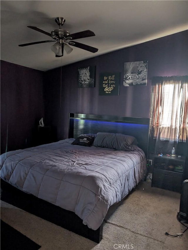 bedroom featuring a ceiling fan and carpet