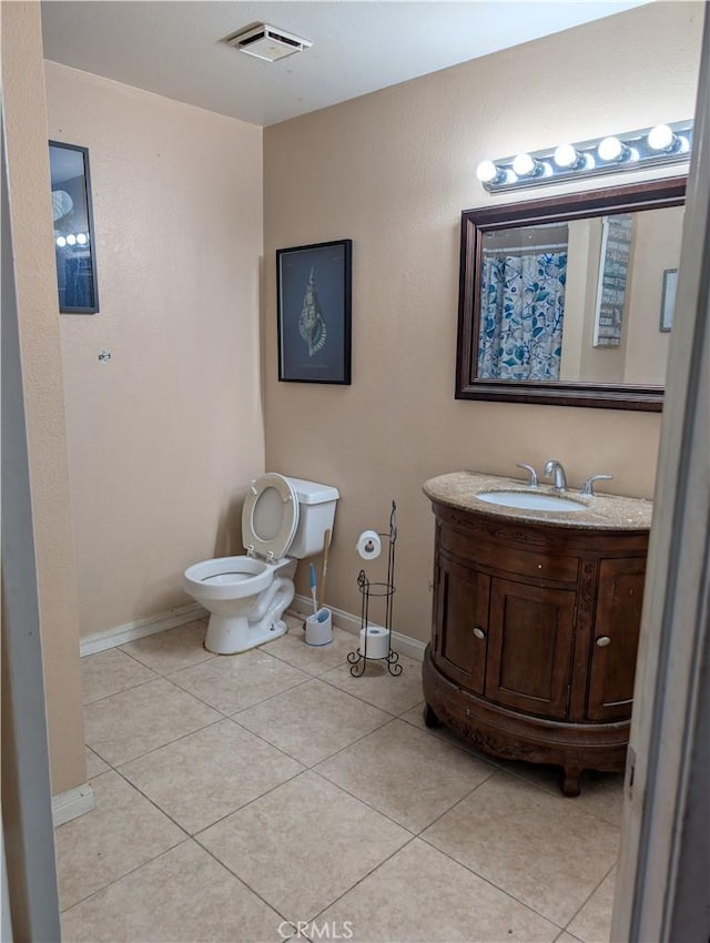 bathroom with toilet, tile patterned floors, visible vents, and baseboards