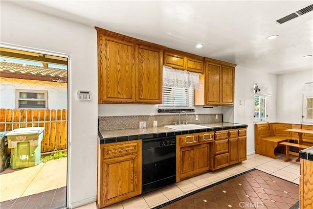 kitchen featuring a sink, visible vents, plenty of natural light, and dishwasher