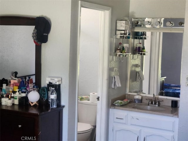 bathroom featuring toilet and vanity