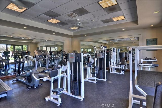 exercise room with a tray ceiling and a drop ceiling