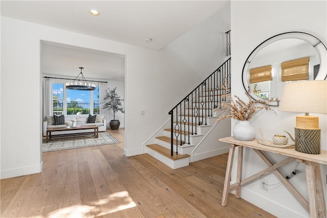 foyer with wood-type flooring, recessed lighting, baseboards, and stairs