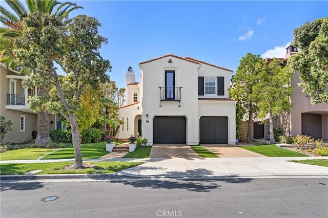 mediterranean / spanish-style house featuring stucco siding, driveway, an attached garage, a front yard, and a tiled roof