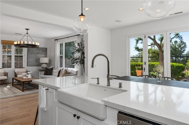 kitchen with a wealth of natural light, pendant lighting, a sink, and recessed lighting