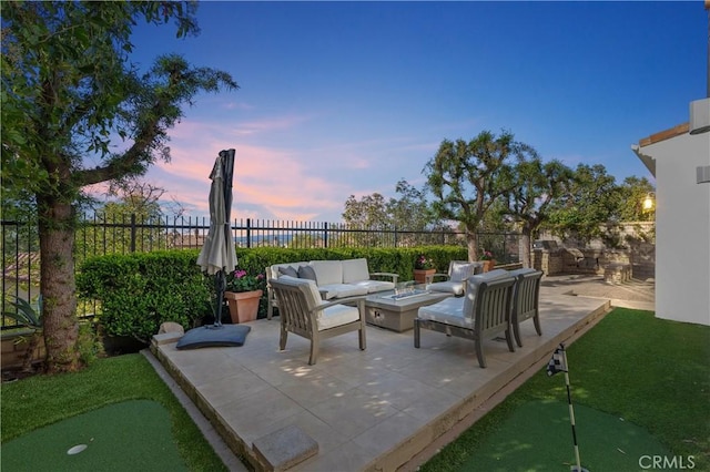 view of patio featuring an outdoor living space with a fire pit and fence