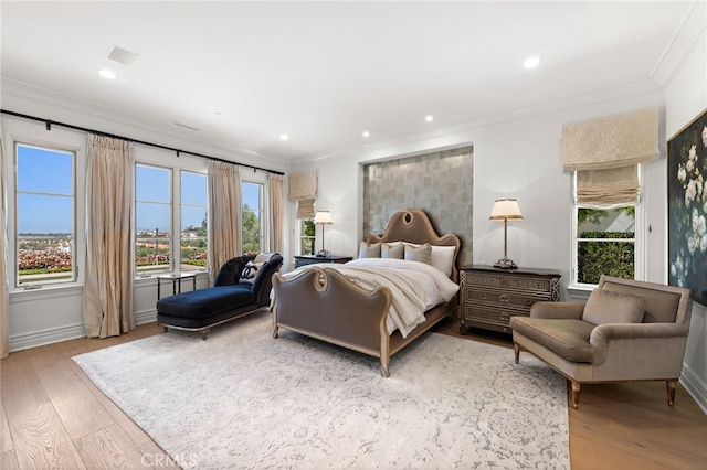 bedroom with recessed lighting, baseboards, ornamental molding, and wood finished floors