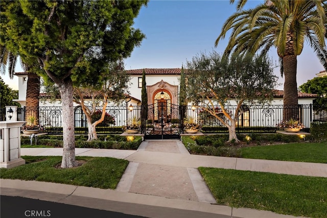 mediterranean / spanish-style house featuring playground community, a tiled roof, stucco siding, and fence