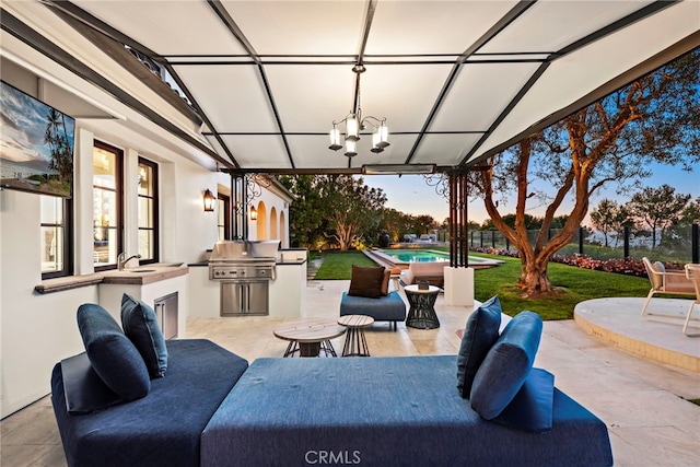 view of patio / terrace with a grill, outdoor lounge area, a sink, exterior kitchen, and an outdoor pool
