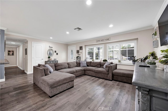 living room with recessed lighting, wood finished floors, and visible vents